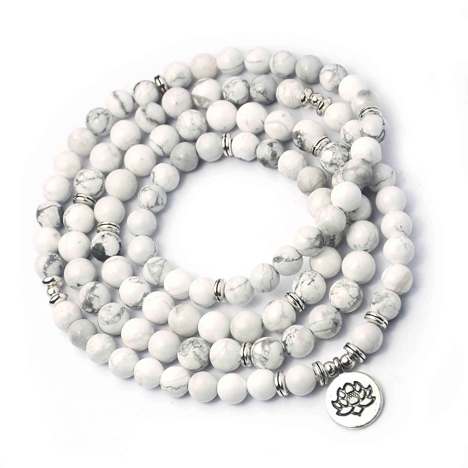 White beaded bracelet with silver accents on a white background
